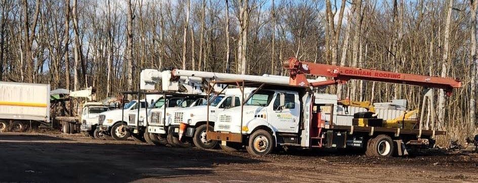 A Row of Trucks Parked Next to Each Other in A Parking Lot – Lawrence Township, NJ – Carroll Tree Service