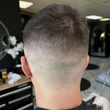 The back of a man 's head with a fade haircut.