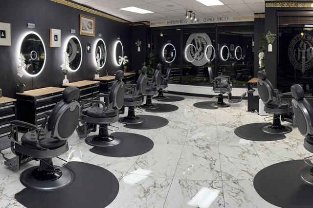 A barber shop with a lot of chairs and mirrors