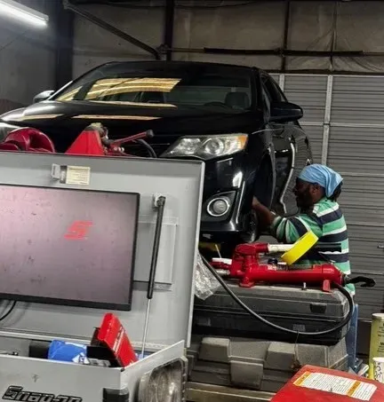 Andre at work on black car in our garage | Gary's Automotive Again
