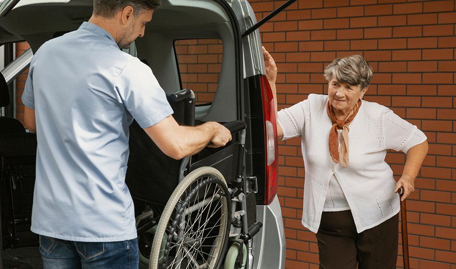 Caregiver Holding The Wheelchair For Elderly Woman — Lawrenceville, GA — Professional and Quality Home Care