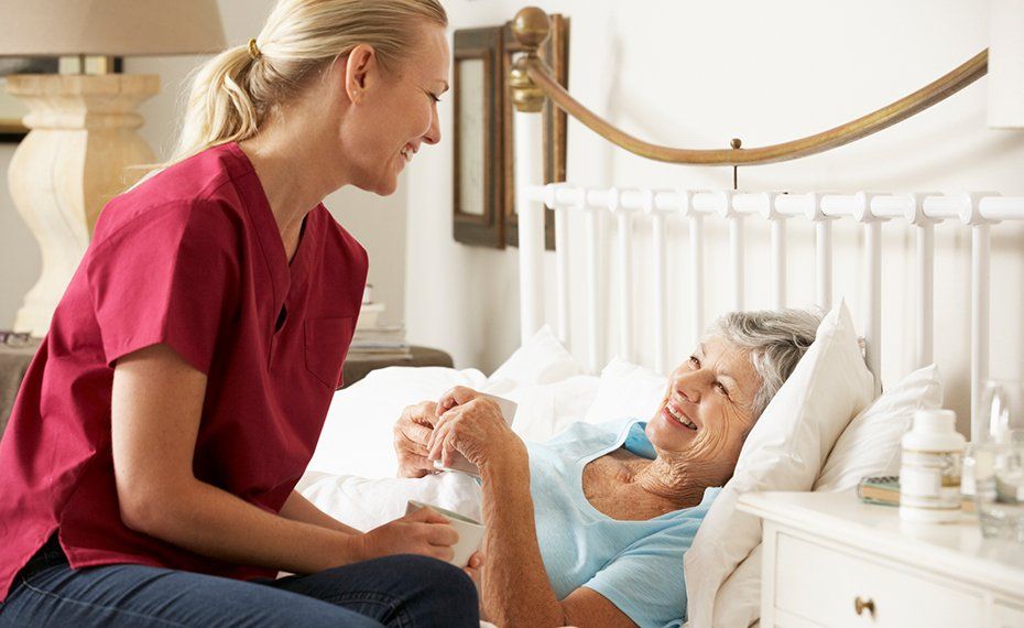 Woman Checking The Eldery Woman On Bed — Lawrenceville, GA — Professional and Quality Home Care
