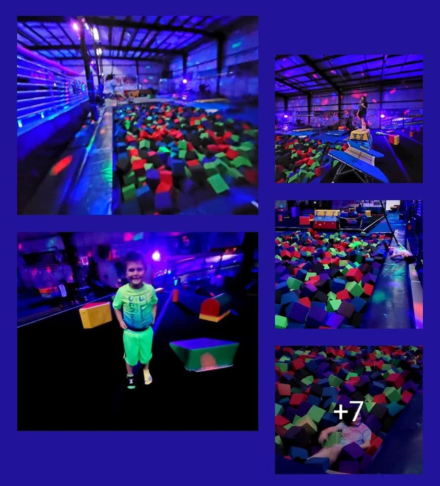Child in neon green clothing at a blacklight trampoline park with foam pit.