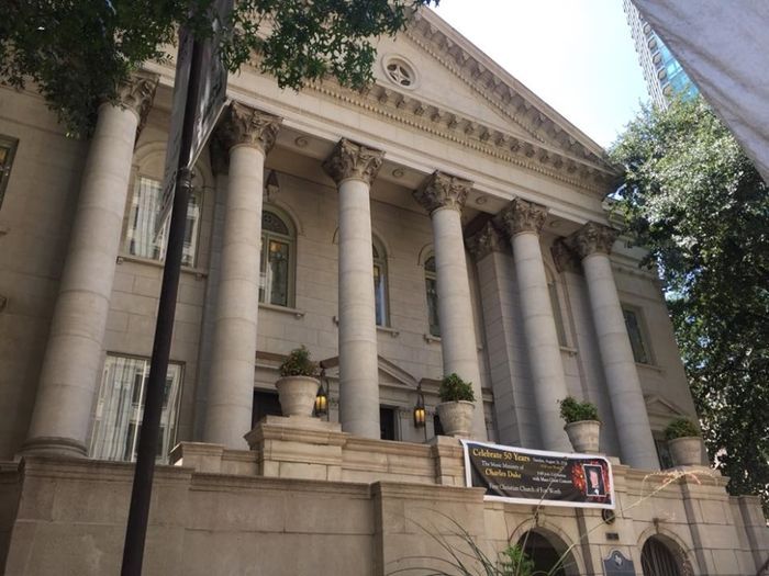 A large building with columns and a banner on the side