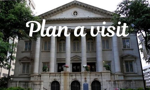 A large building with the words plan a visit on it