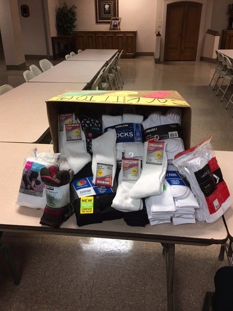 A box full of socks sits on a table
