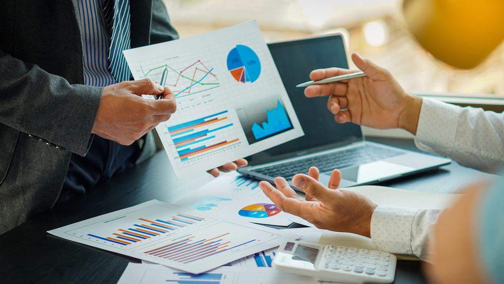 Business Meeting: Hands Pointing at Charts With Graphs — Precision Financial & Tax In Ross Creek, VIC