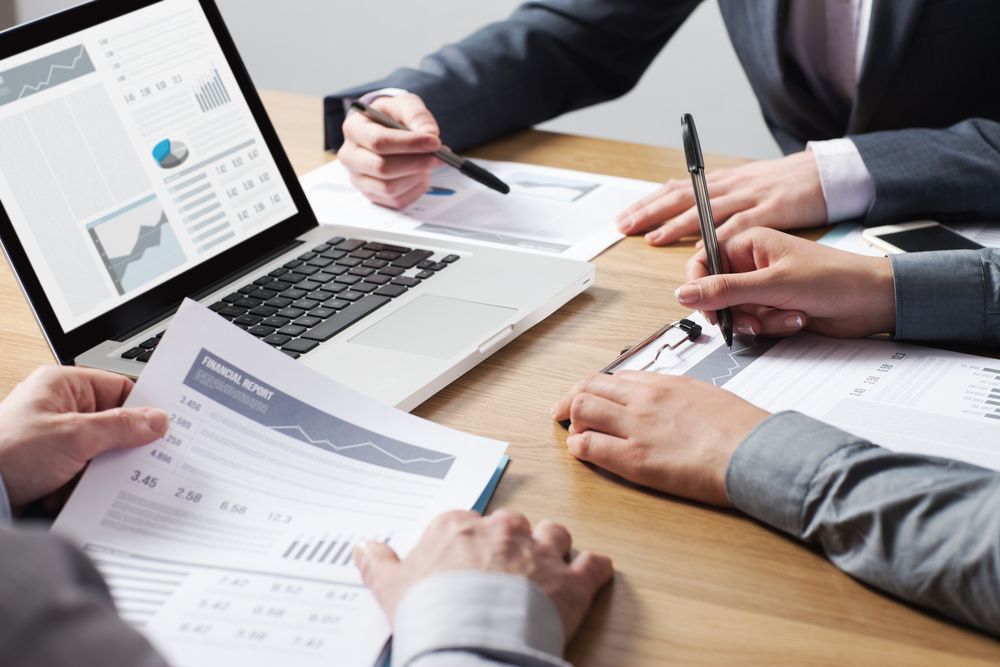 People in Business Attire Reviewing Financial Reports — Precision Financial & Tax In Ross Creek, VIC