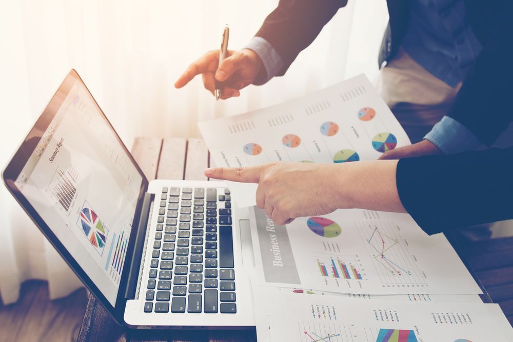 Two People Analyzing Financial Data on a Laptop — Precision Financial & Tax In Ross Creek, VIC