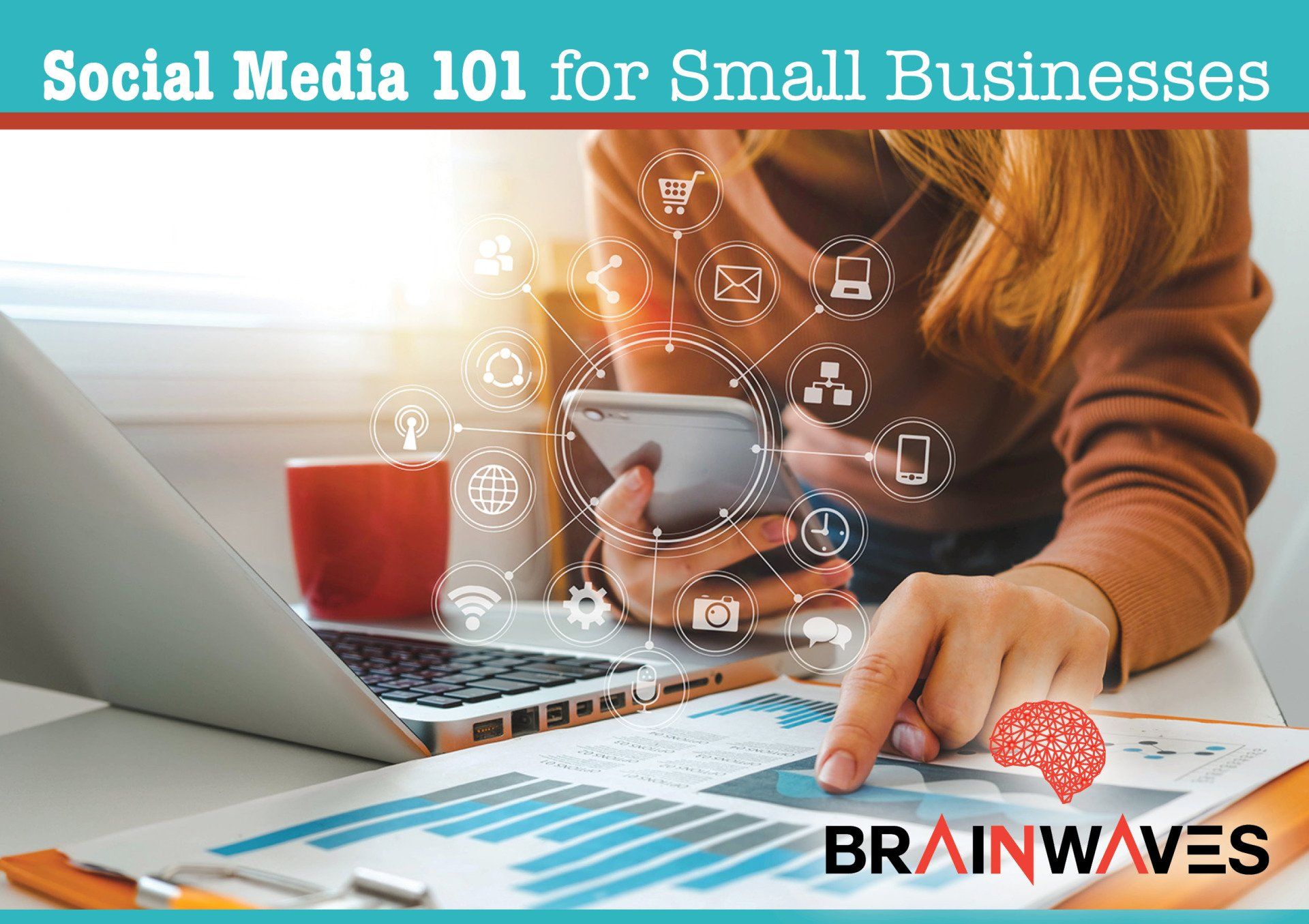 A woman is sitting at a desk using a laptop and a cell phone.