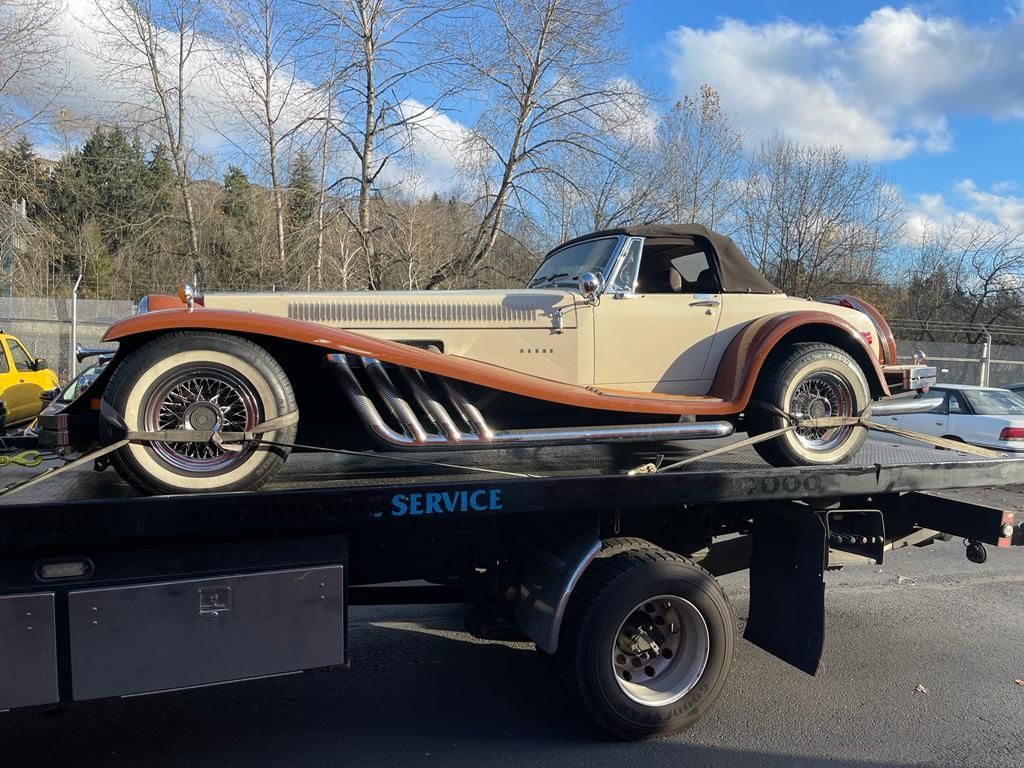 A car is being towed by a tow truck.