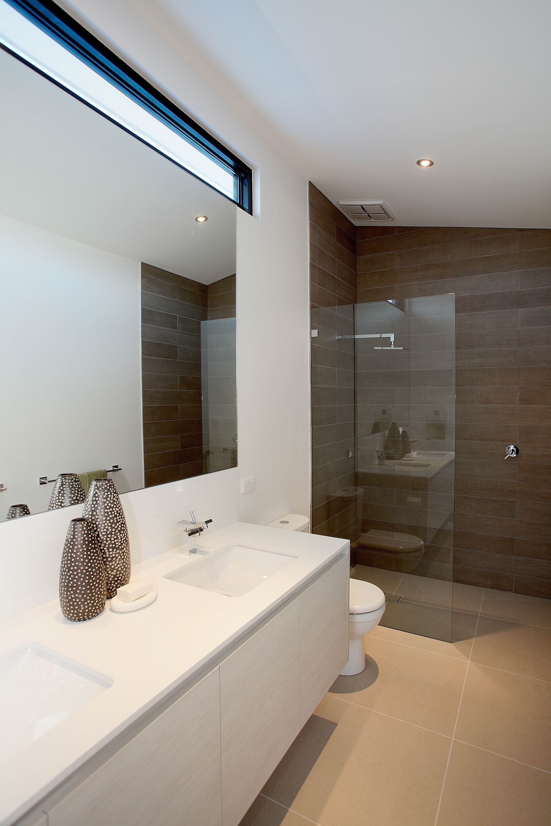 A Bathroom With A Toilet A Sink And A Walk In Shower — KM Custom Homes In Mount Eliza, VIC