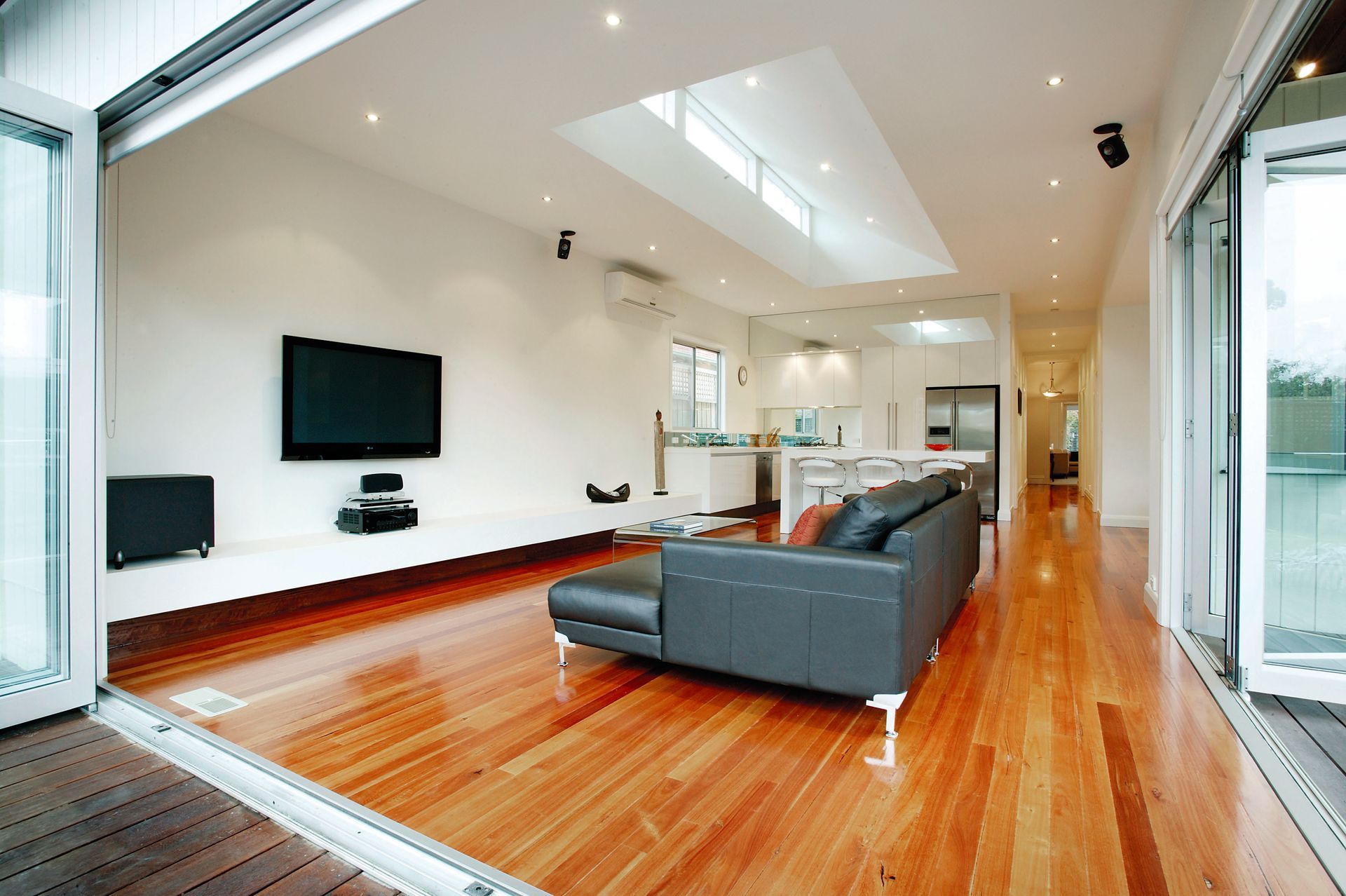 A Living Room With A Couch And A Flat Screen Tv — KM Custom Homes In Mount Eliza, VIC
