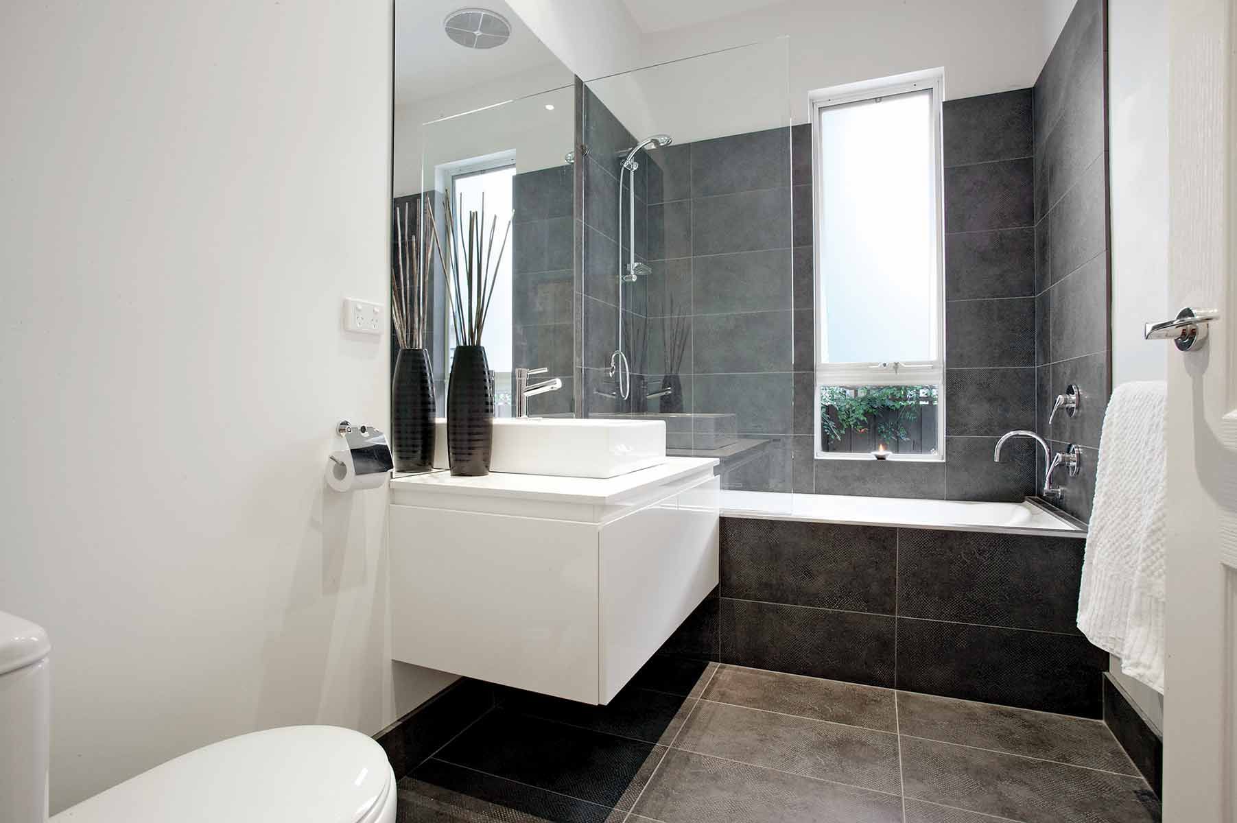 A Bathroom With A Toilet, Sink, And Bathtub — KM Custom Homes In Mornington Peninsula, VIC