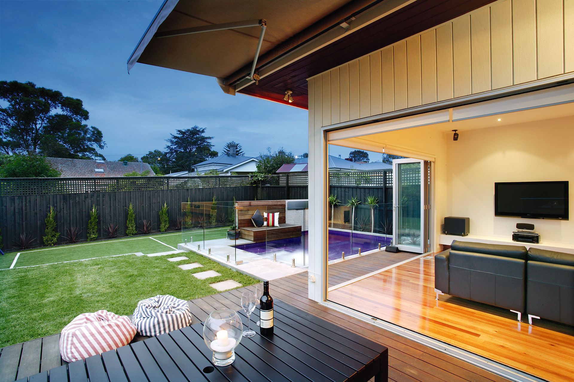A Modern House With a Wooden Deck and Sliding Glass Doors — KM Custom Homes In Mount Eliza, VIC