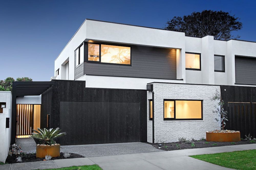 A White and Gray House With a Black Garage Door — KM Custom Homes In Mount Eliza, VIC