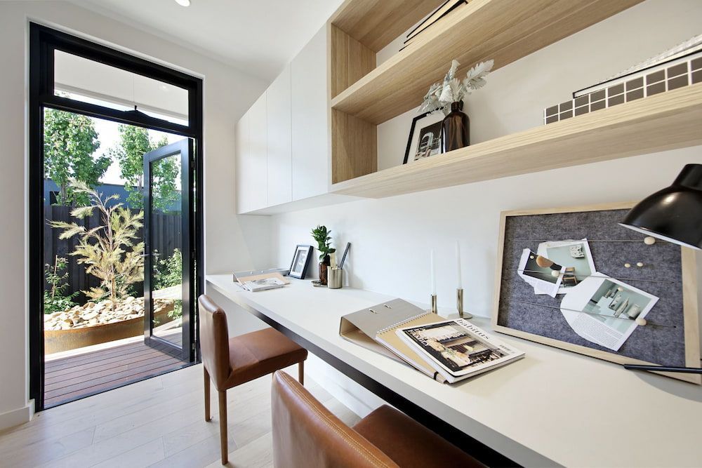There Is A Desk With A Chair And A Lamp In The Room — KM Custom Homes In Frankston South, VIC