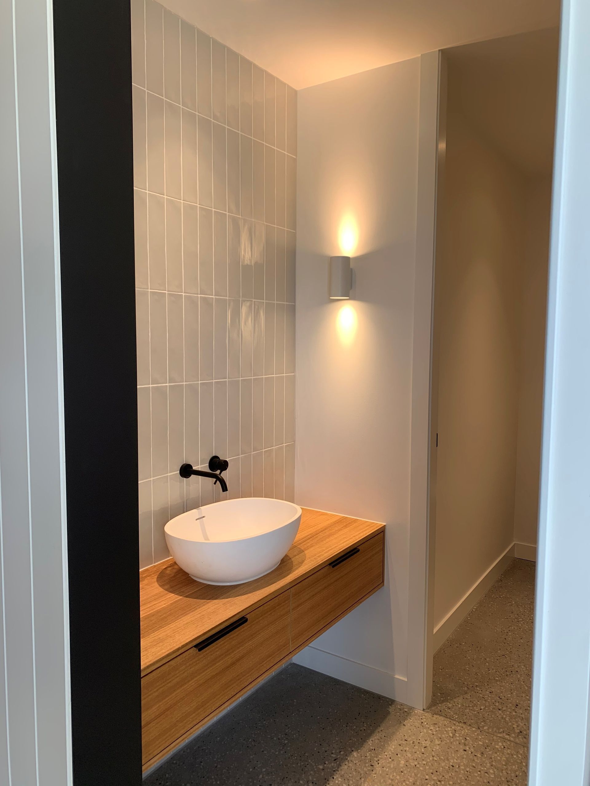 A Bathroom With A Sink On A Wooden Counter — KM Custom Homes In Mornington, VIC