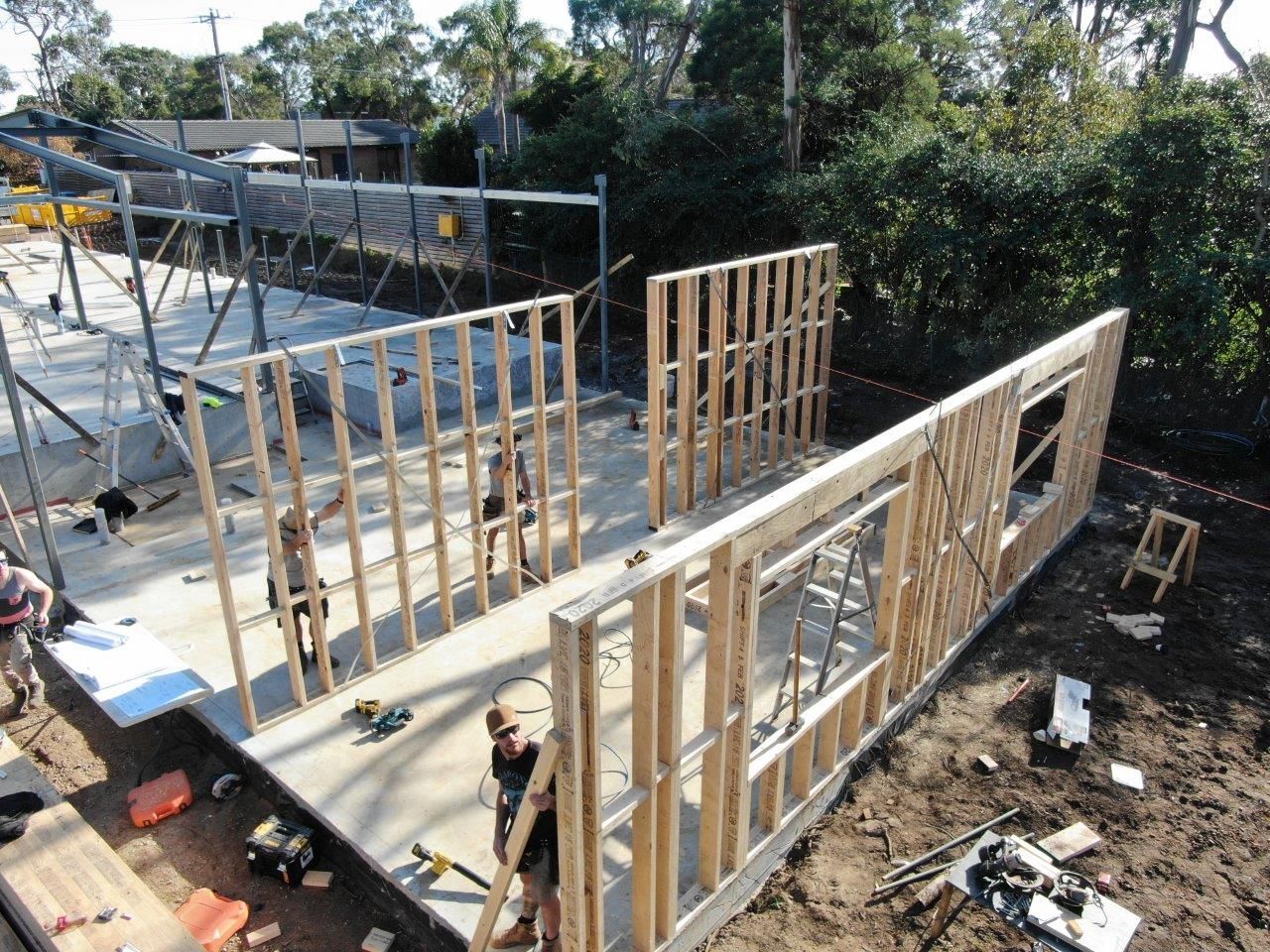 A Group Of People Are Working On A House Under Construction — KM Custom Homes In Mount Eliza, VIC