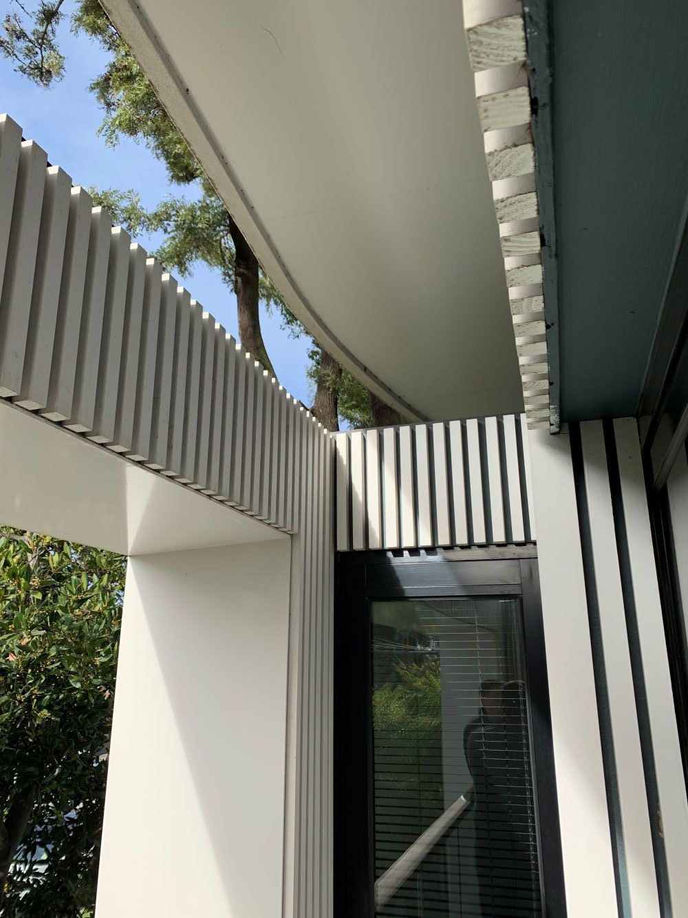 A White Building With A Black Door And A White Roof — KM Custom Homes In Red Hill, VIC