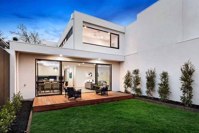 The Backyard of a Modern House With a Large Lawn and a Deck — KM Custom Homes In Mount Eliza, VIC