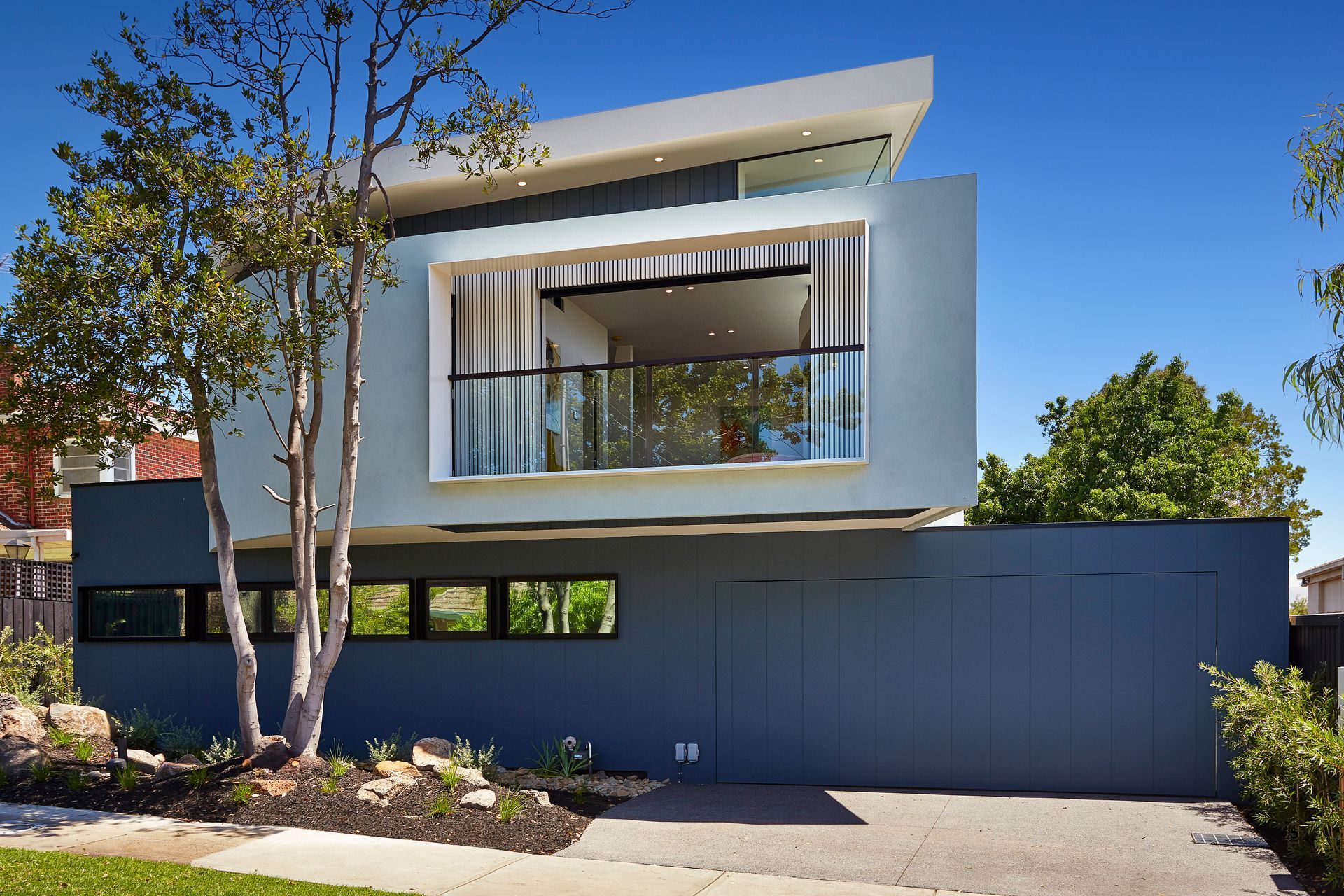 A Modern House With a Large Garage and a Balcony — KM Custom Homes In Mount Eliza, VIC