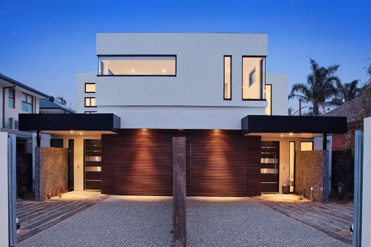 A Modern House With Two Garage Doors and a Driveway — KM Custom Homes In Mount Eliza, VIC