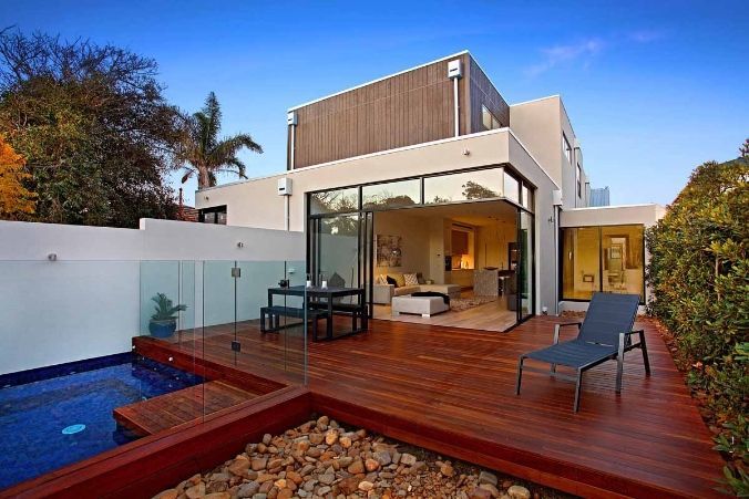 A Modern House With a Swimming Pool and a Wooden Deck — KM Custom Homes In Mount Eliza, VIC