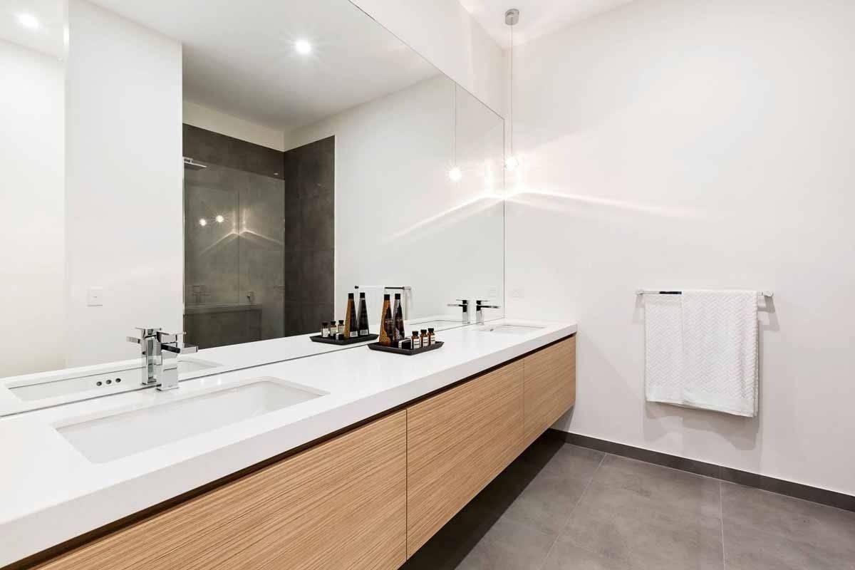 A Bathroom With Two Sinks and a Large Mirror — KM Custom Homes In Mount Eliza, VIC