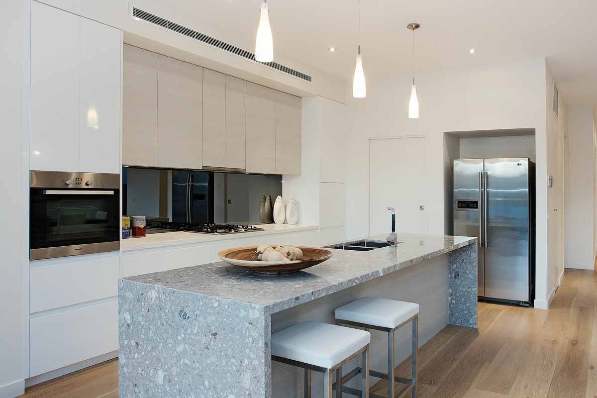 A Kitchen With White Cabinets and Granite Counter Tops — KM Custom Homes In Mount Eliza, VIC