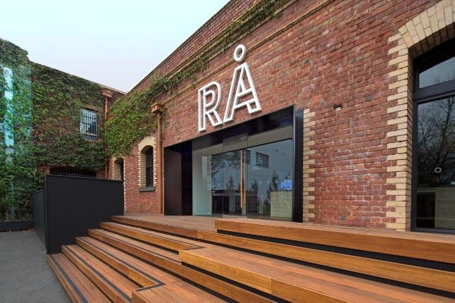 A Brick Building With Wooden Stairs Leading Up to It  — KM Custom Homes In Mount Eliza, VIC