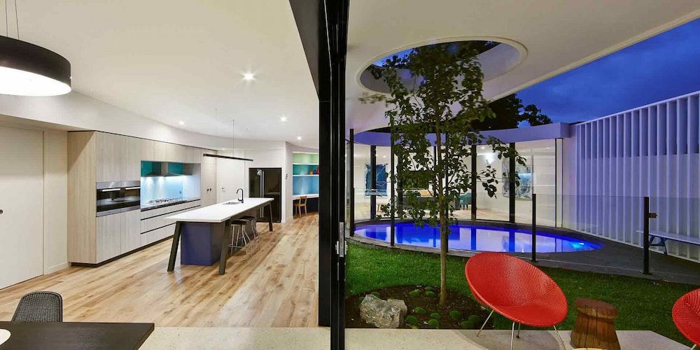 There Is A Swimming Pool In The Backyard Of A House — KM Custom Homes In Mount Eliza, VIC