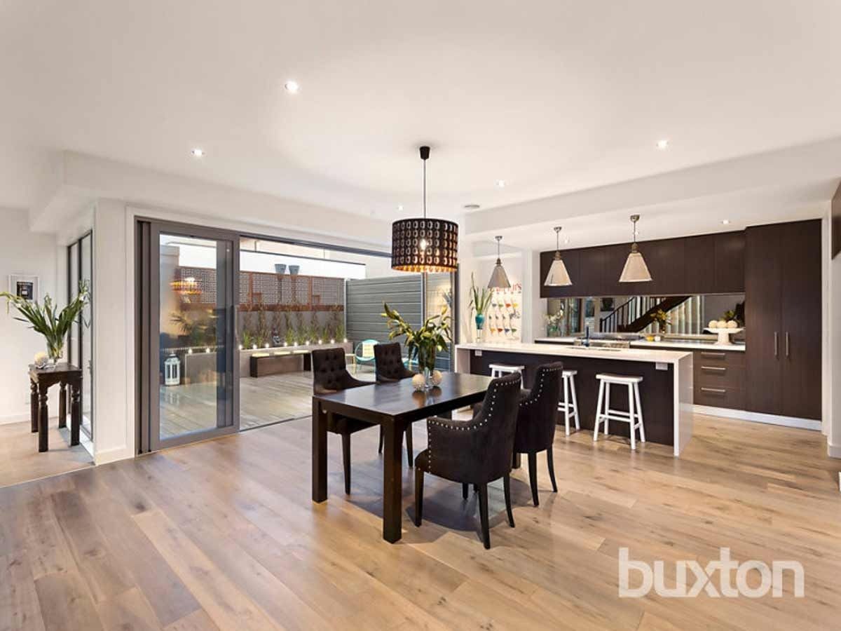 A Dining Room With a Table and Chairs and a Kitchen — KM Custom Homes In Mount Eliza, VIC