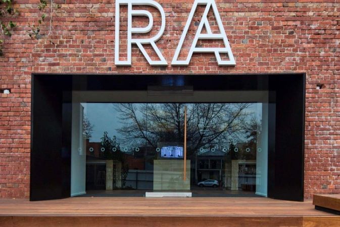 A Brick Building With a Glass Door and the Word RA on It  — KM Custom Homes In Mount Eliza, VIC