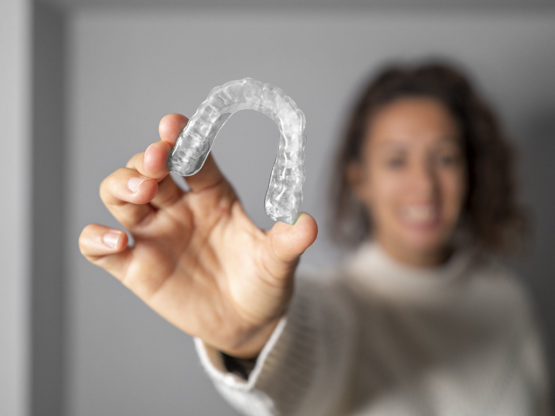 Woman Holding an Invisalign — Caldwell, ID — Webster Orthodontics