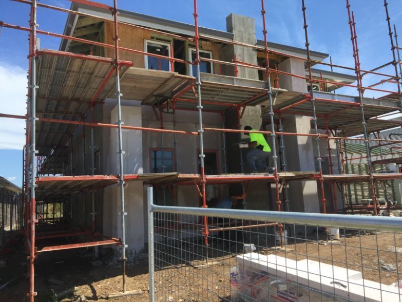 a large house is being built with scaffolding around it .