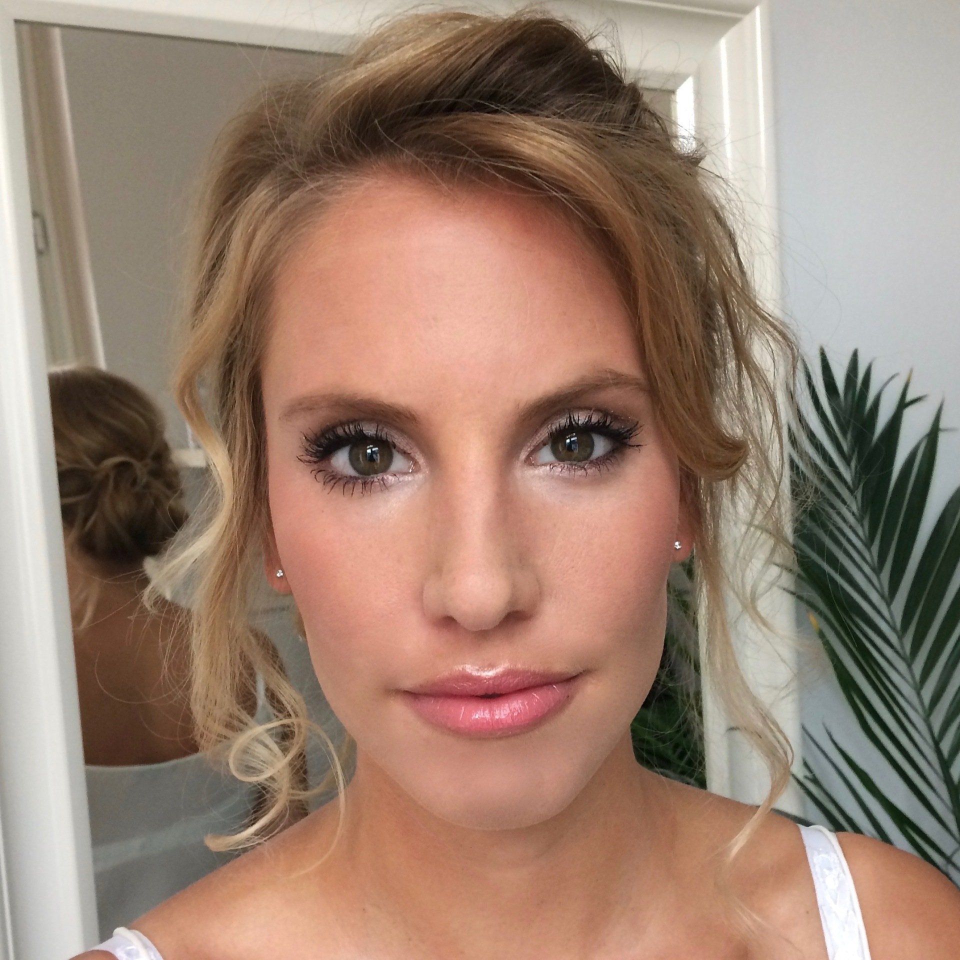 Eine Nahaufnahme des Gesichts einer Frau mit einer Palme im Hintergrund