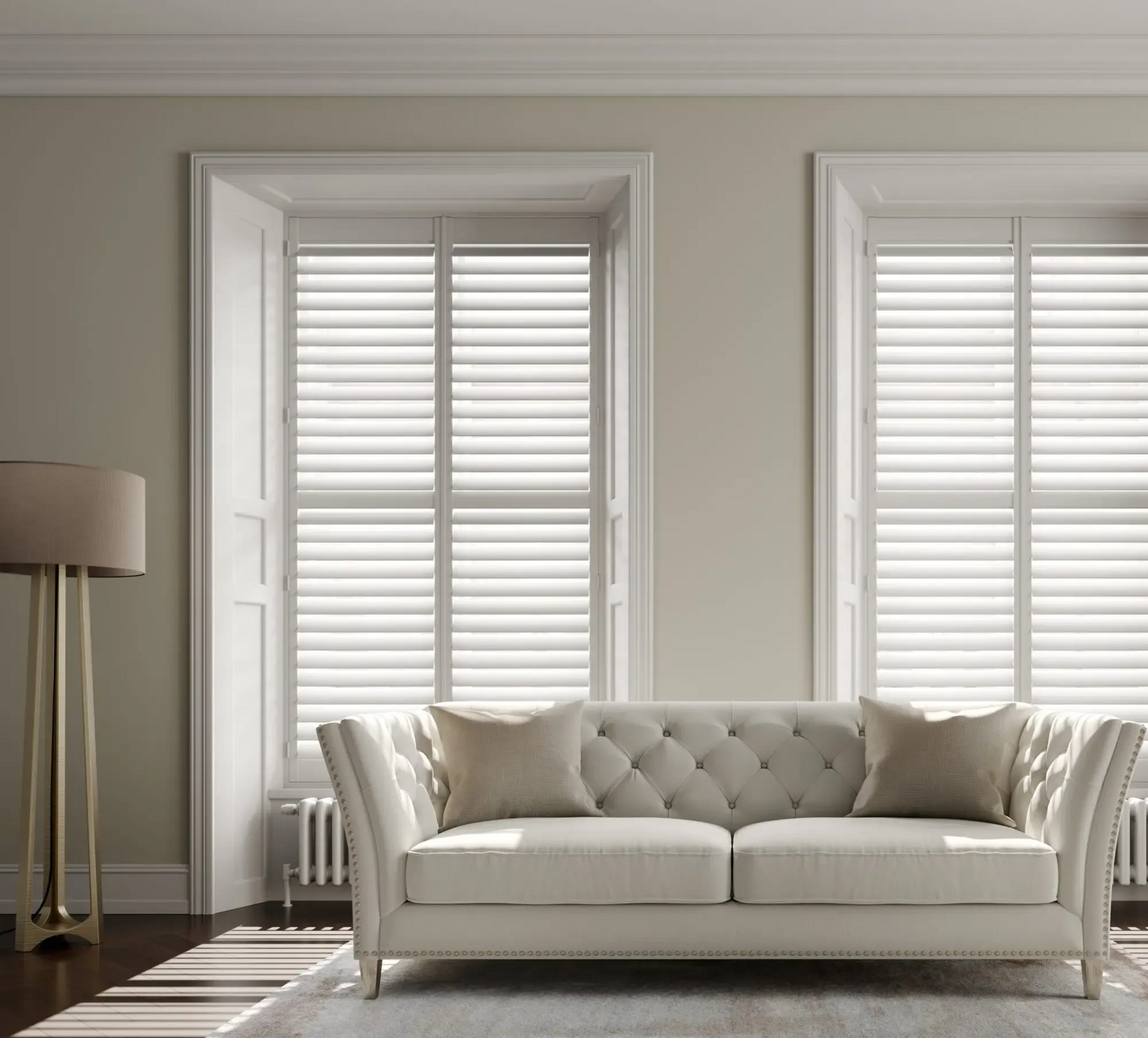 Wooden door with brick archway set in a red wall; green bush at left.