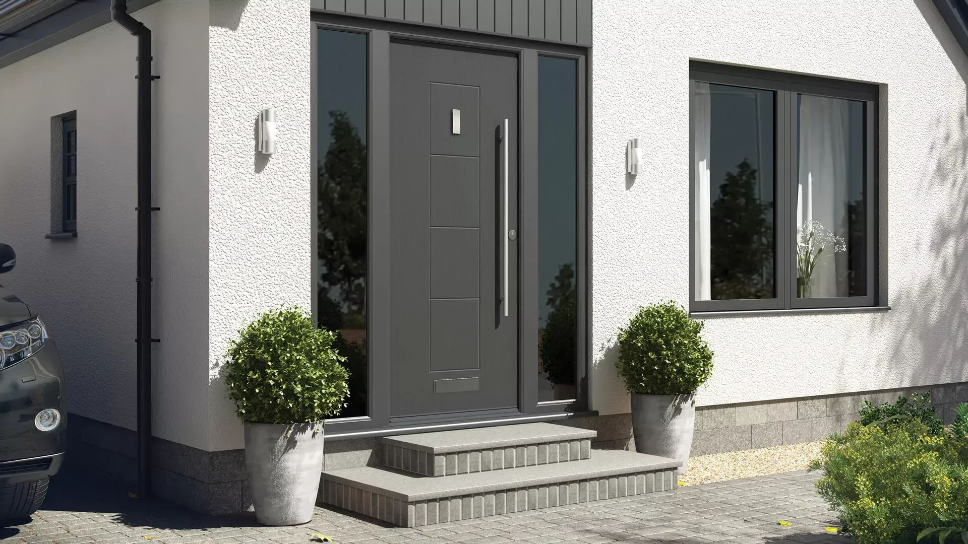 Gray front door with sidelights, steps, and potted plants; white stucco exterior.