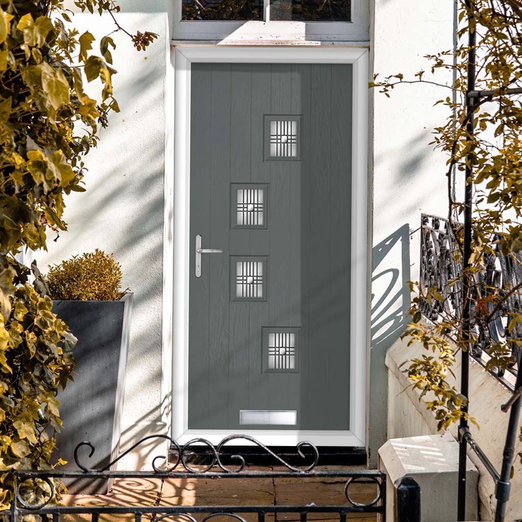 Gray front door with four small windows, silver handle, and white frame.