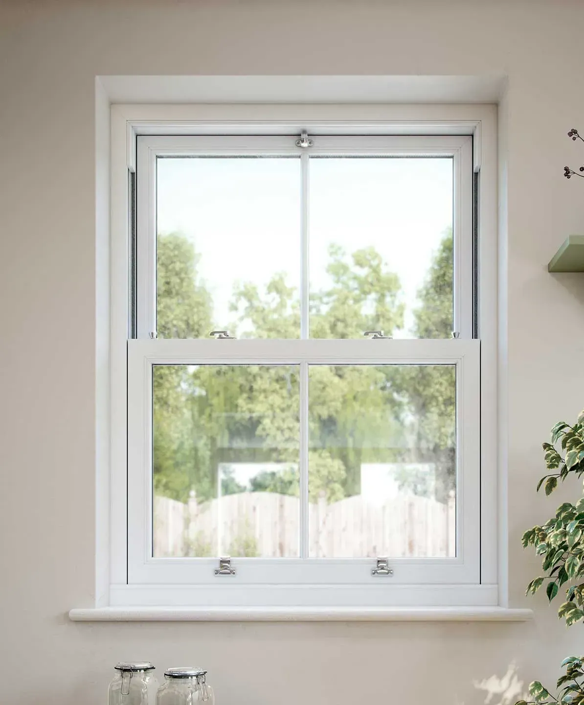 White sash window with green trees visible through the glass.