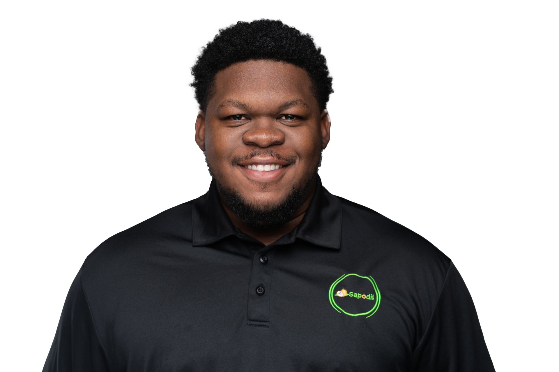 A man with a beard is wearing a black polo shirt and smiling.