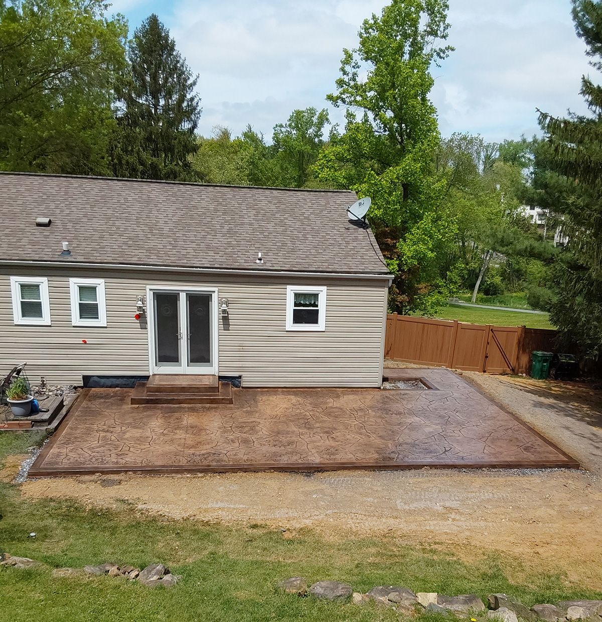 A house with a concrete patio in front of it