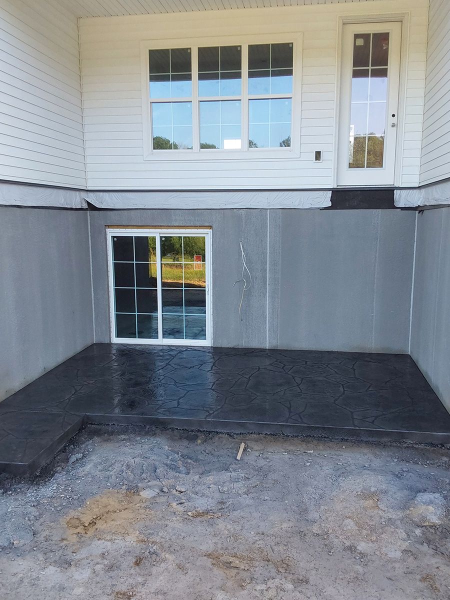 A basement with a sliding glass door and a window