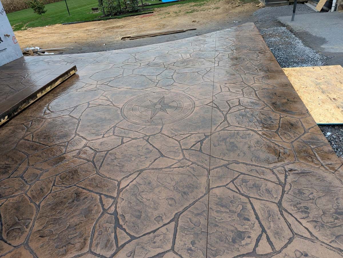 A concrete patio with a geometric pattern on it.