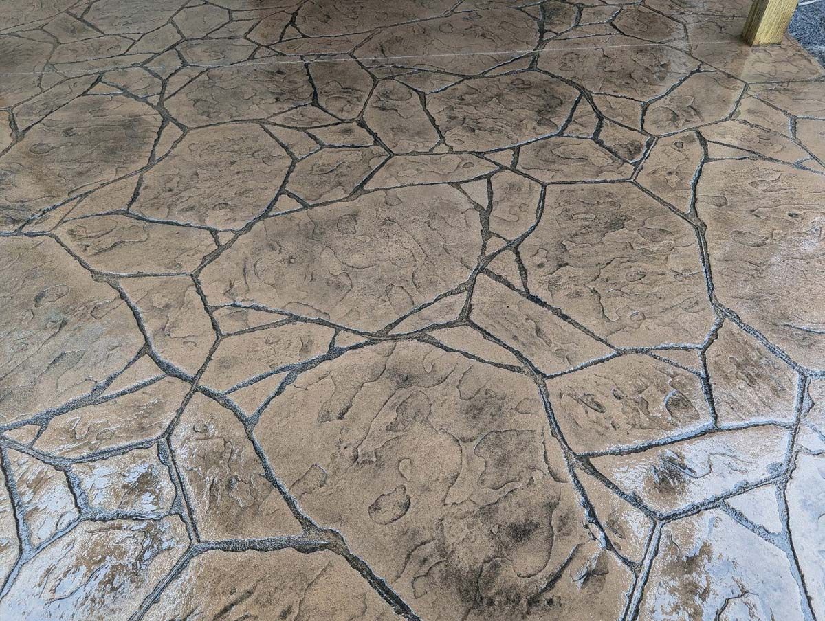 A close up of a concrete floor with a rock pattern.