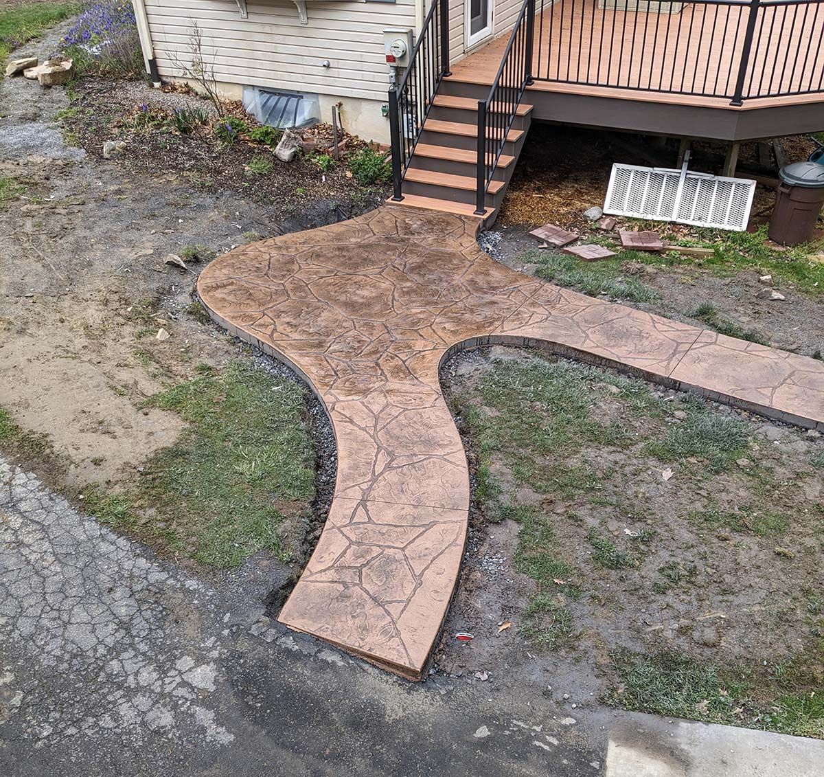 An aerial view of a concrete walkway leading to a deck.