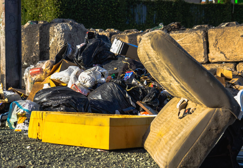 pile of trash with bins outside 