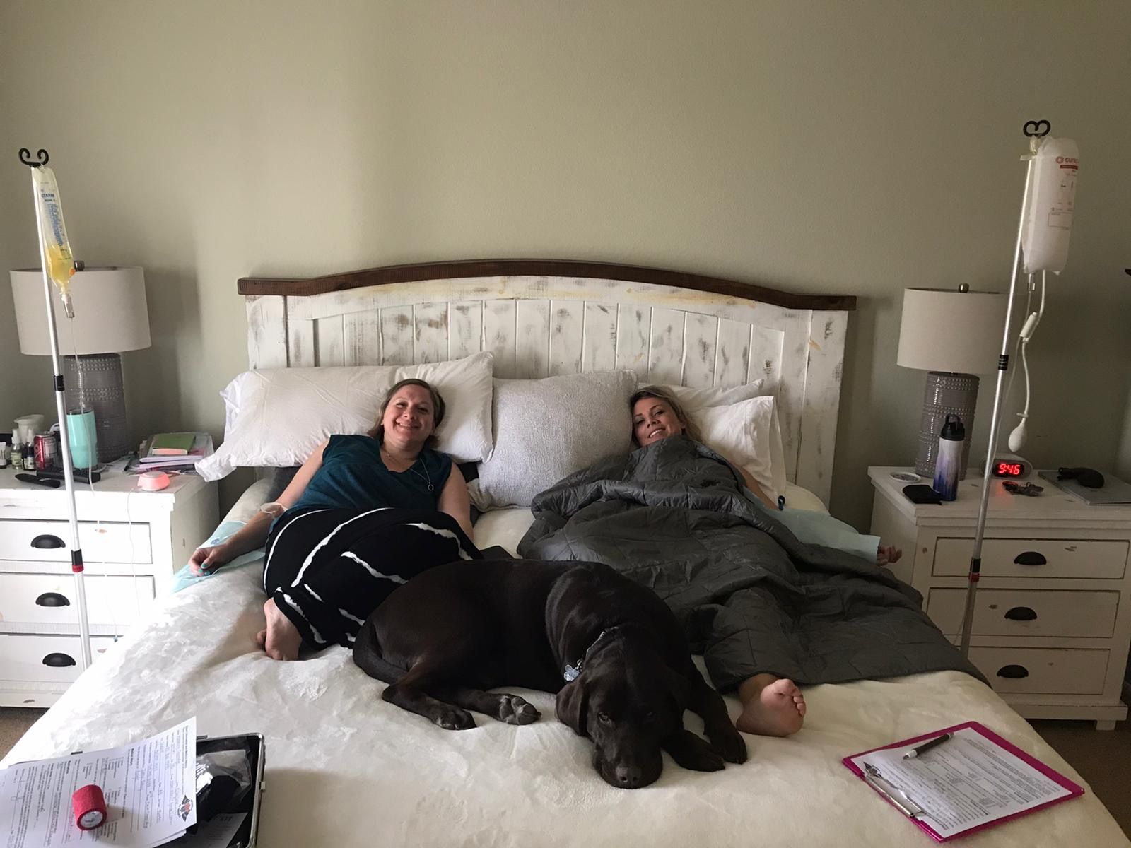 Two men are sitting next to each other in a hospital bed.