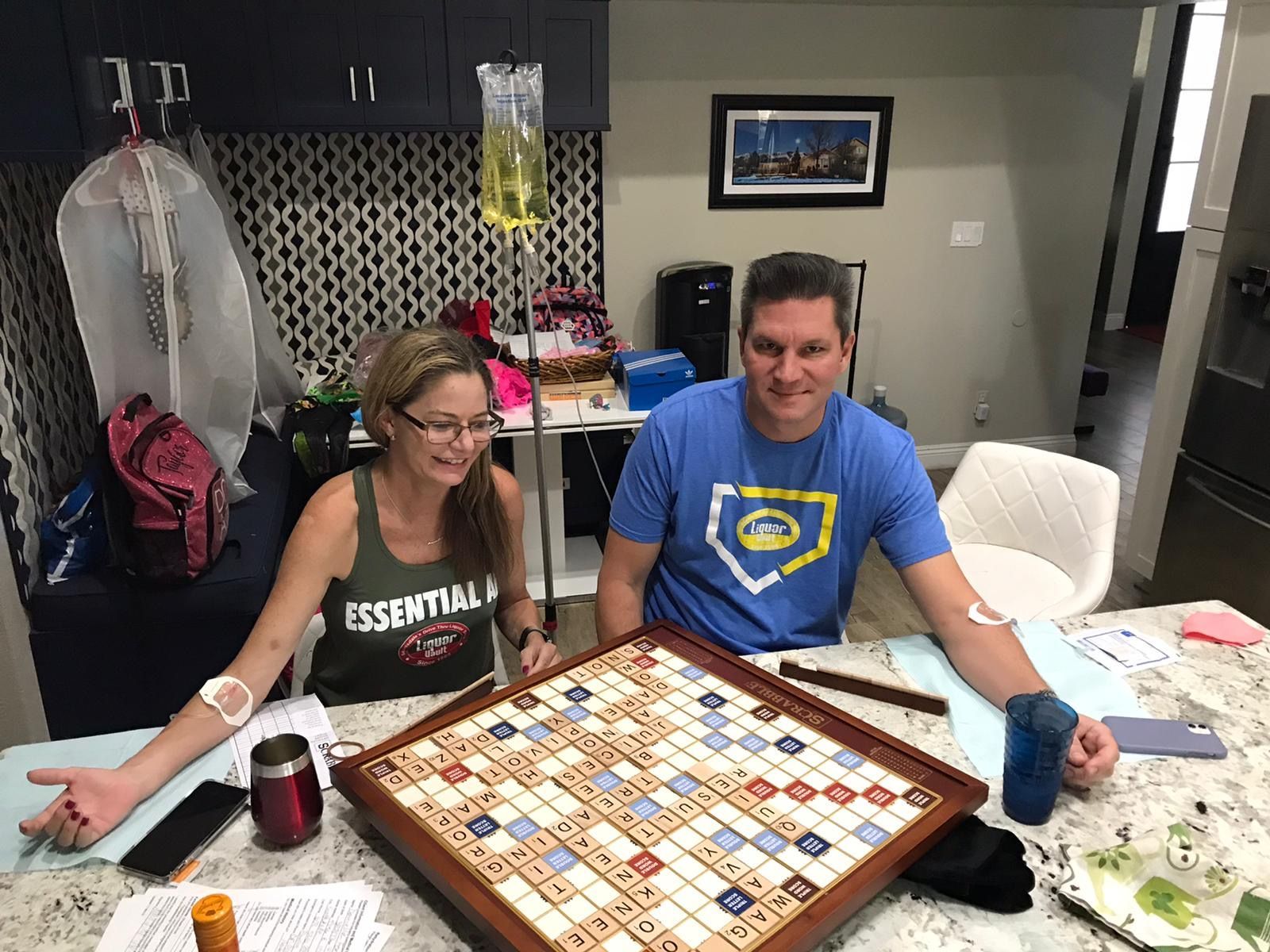 Two men are sitting next to each other in a hospital bed.